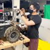 Dan Torres wears a mask while working on one of the DARPA Subterranean Challenge robots