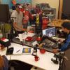 Three students experiment with human-robot interaction and autonomous manipulation in the Correll Lab.