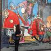 Kelly admires a mural on a building