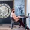 A student wears a face covering while working in the CASE building. (Photo by Glenn Asakawa/University of Colorado)