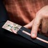 A close-up view of the wearable device being controlled with a finger swipe.
