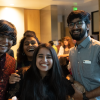 People smile at camera at cross-cultural event