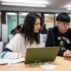 Two students looking at computer screens
