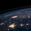 A view of the Earth from space, showing clusters of lights in cities.