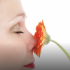 Short red haired person smells orange flower