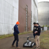 Michael Miles and Daniel Torres talk with another challenge participant during a break outside of the DARPA Subterranean Challenge course area.