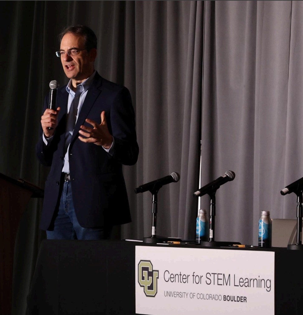 Keynote speaker Phil Weiser addressing the crowd from the podium