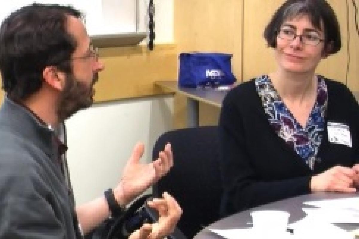 Two professors, sitting at a table, working on course development
