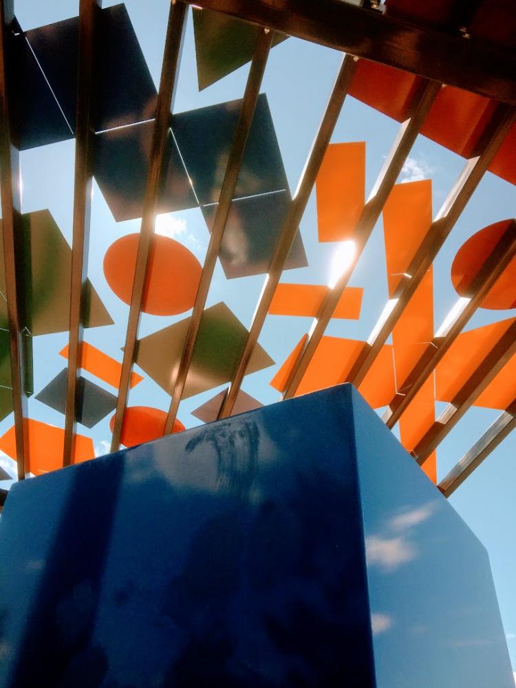 View looking up into a canopy of shapes with a cube in the foreground