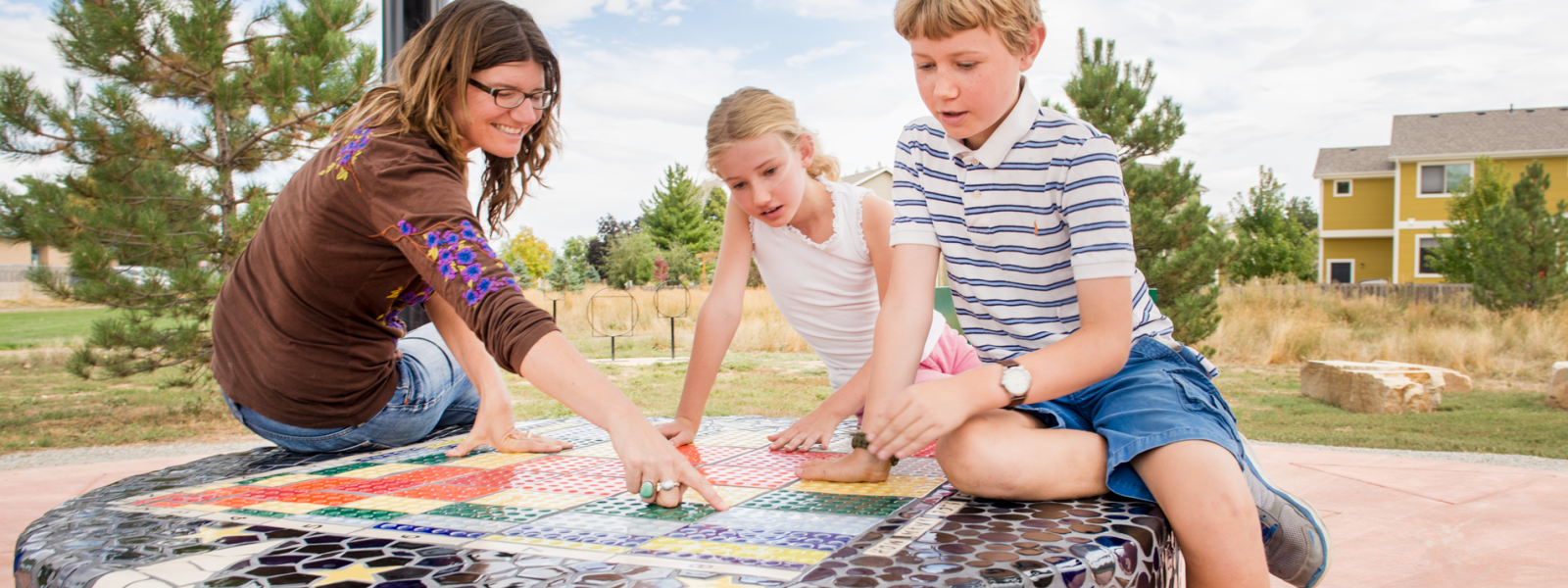 Mom and son and daughter sitting on circular mosaic