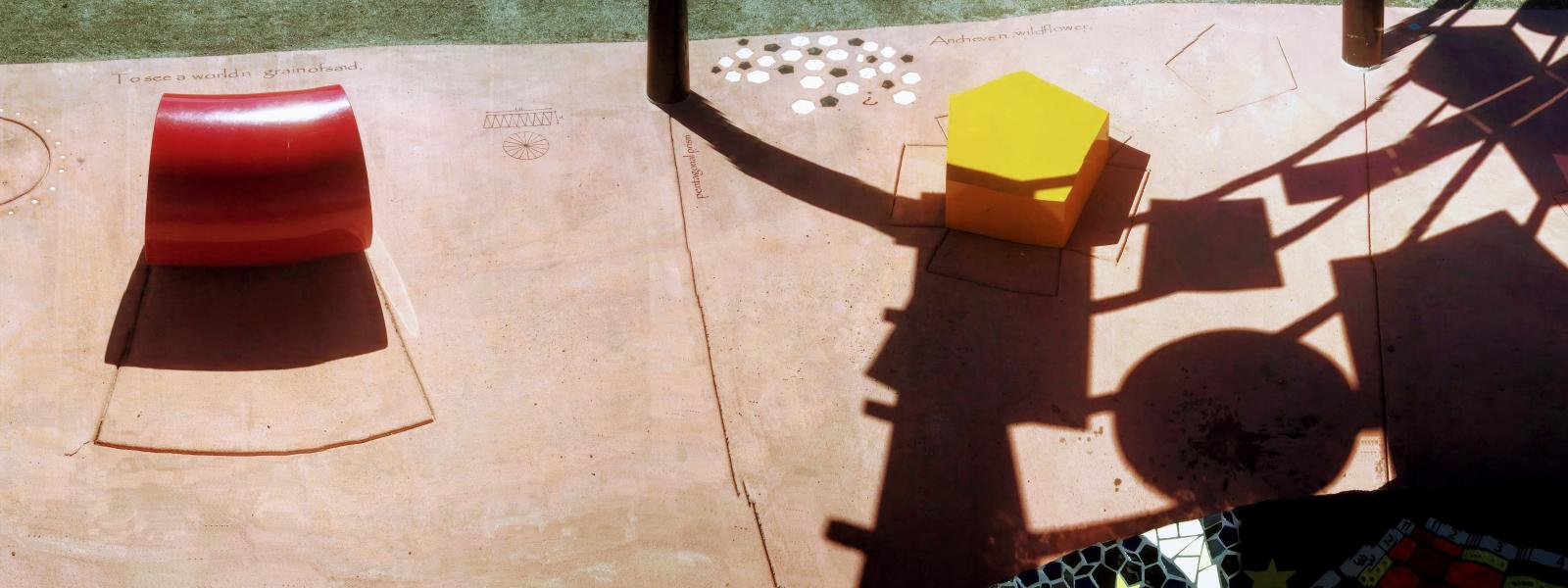 panorama of red cylinder, yellow pentagon and shape shadows from the roof.