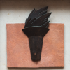 Best Should Teach logo; black metal torch on red stone