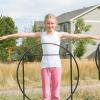 Girl stands behind a set of sculptures of overlapping squares and circles