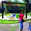 Geometry Park, a mother and daughter walk towards a multi-colored installment in the center of the park