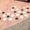 White hexagons and black pentagons embedded in concrete