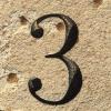 The number 3 etched in stone