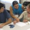 Valerie Otero working with a learning assistant and student