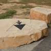 Two rocks, one with triangles on it.