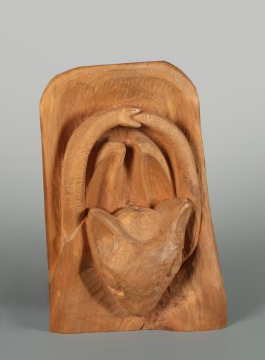 A carved wooden bat