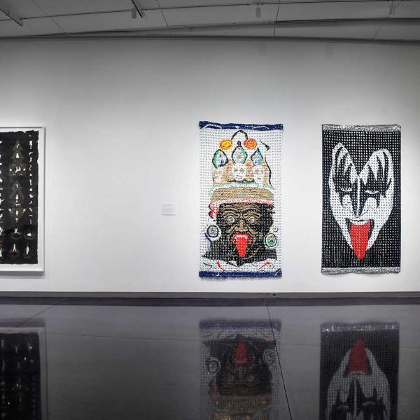 Installation view of three large artworks hung together
