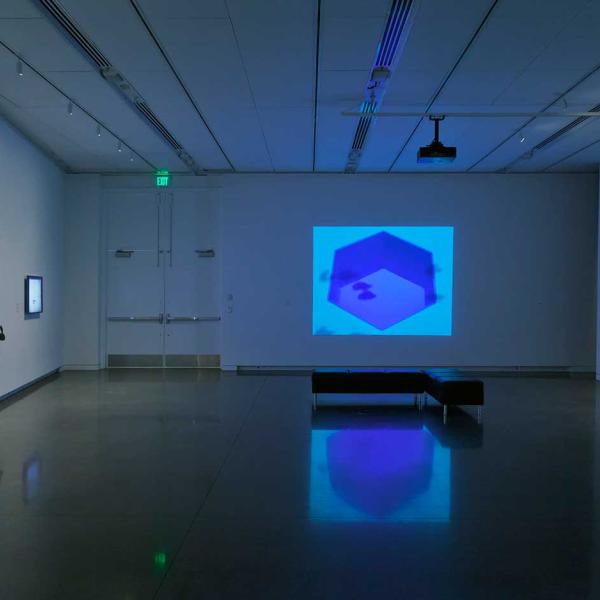 Installation view of the Interlaced exhibition showing monitors and projections