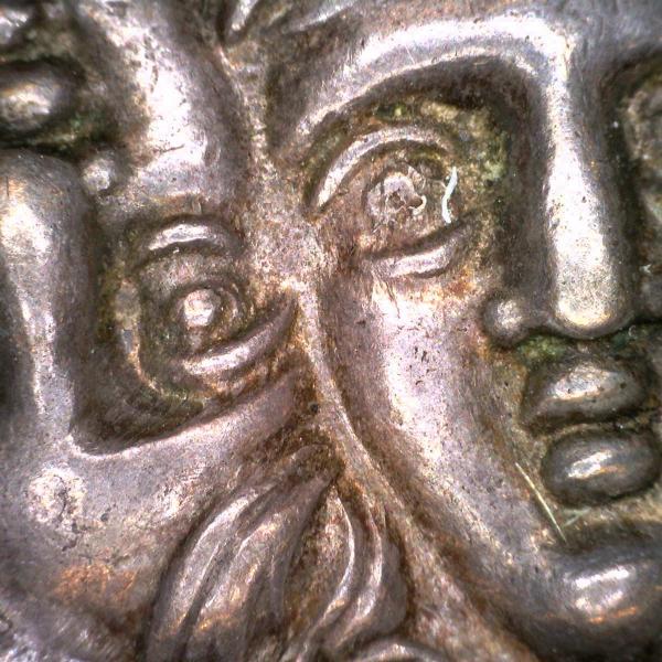 highly magnified detail of a Roman coin depicting two faces