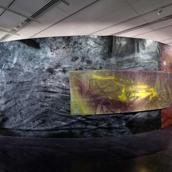 A large curved wall built within the gallery.