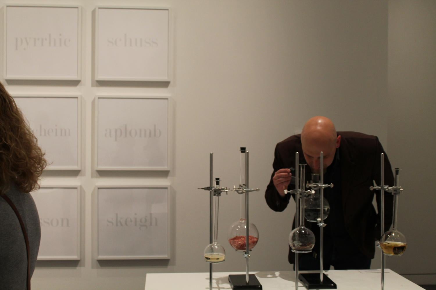 A man looks at a scientific instrument that's part of an art installation.