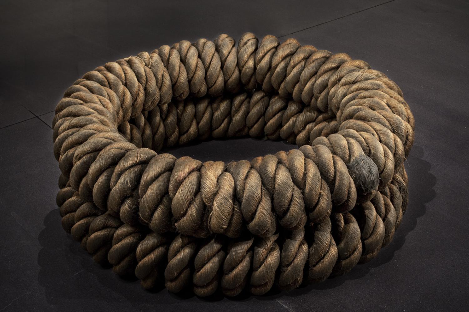 Two hempen ropes twisted and formed into circles and stacked upon each other.