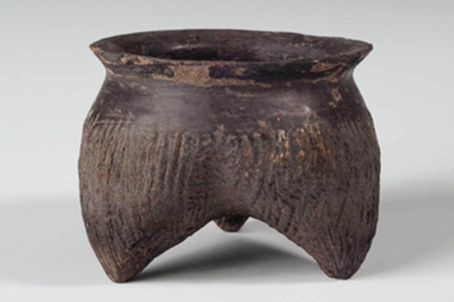 ancient three-legged ceramic bowl