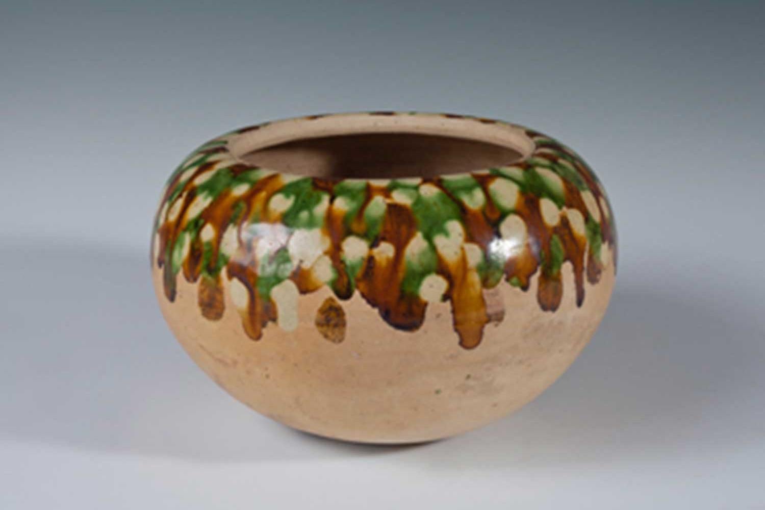 ancient ceramic bowl with brown and green glazing