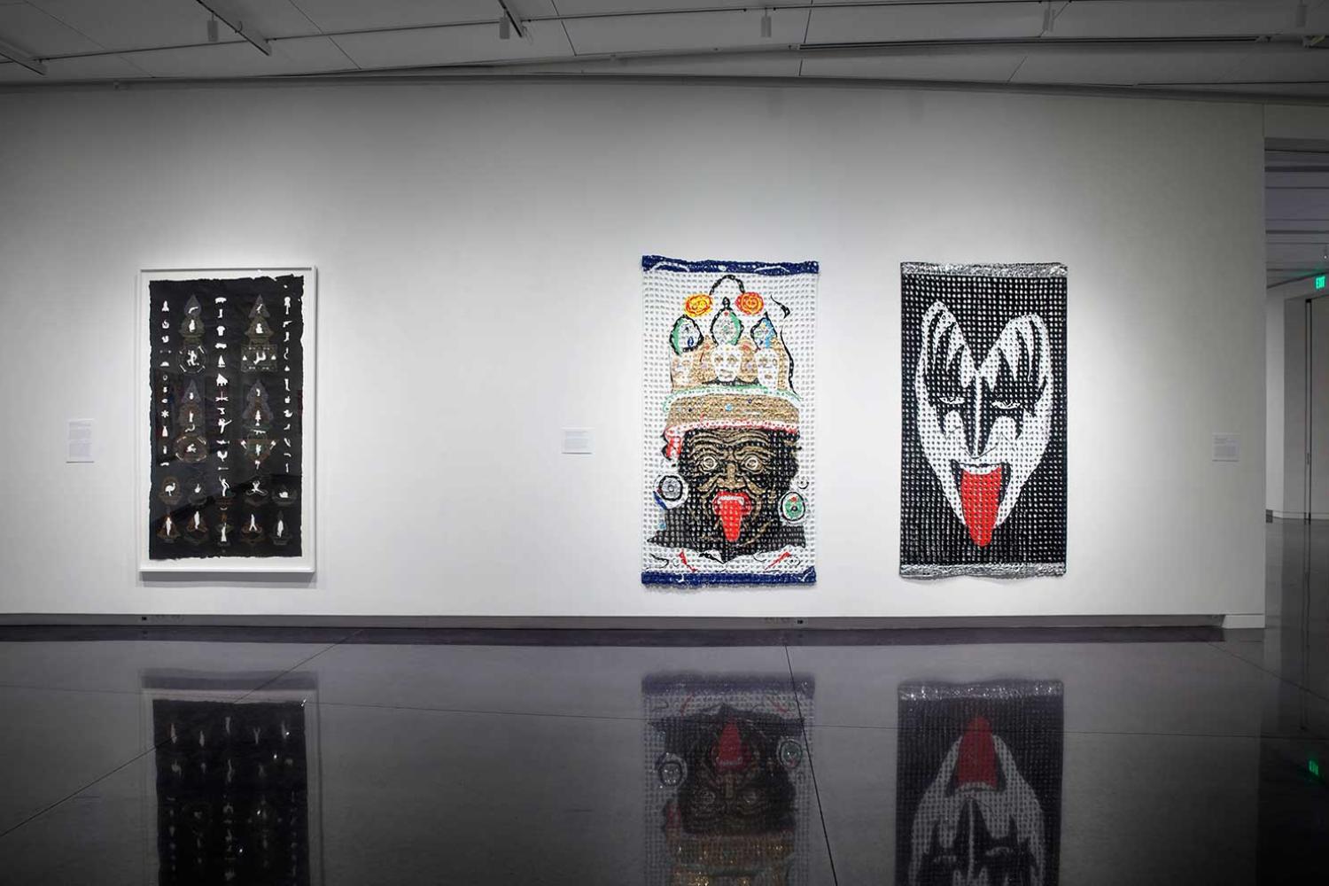 Installation view of three large artworks hung together