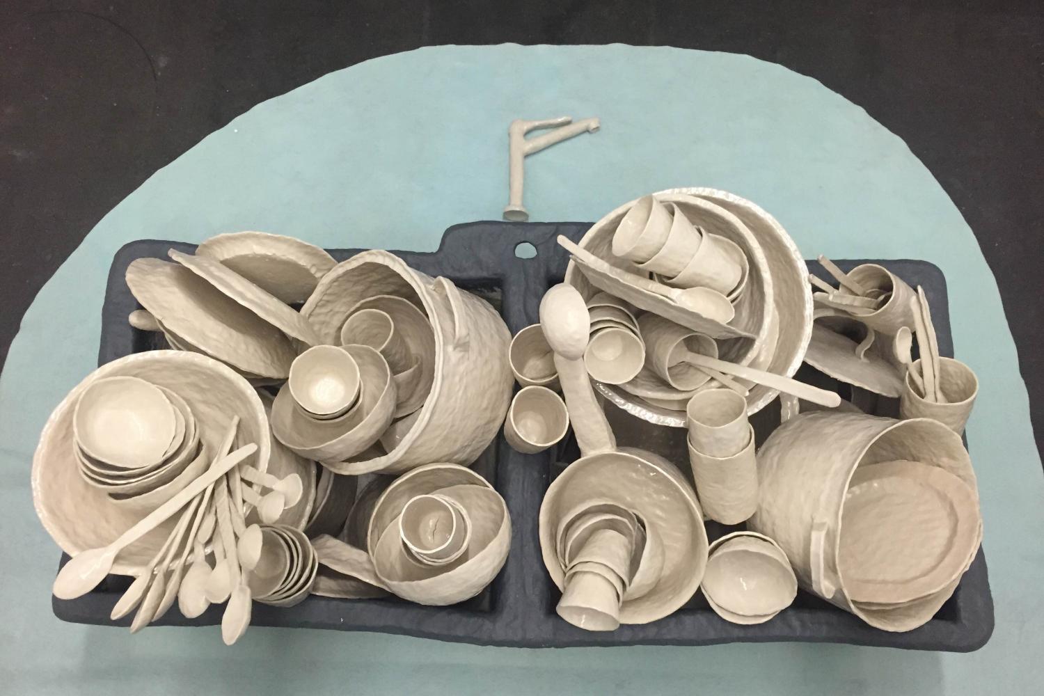 Ceramic replicas of kitchen tools and a sink.