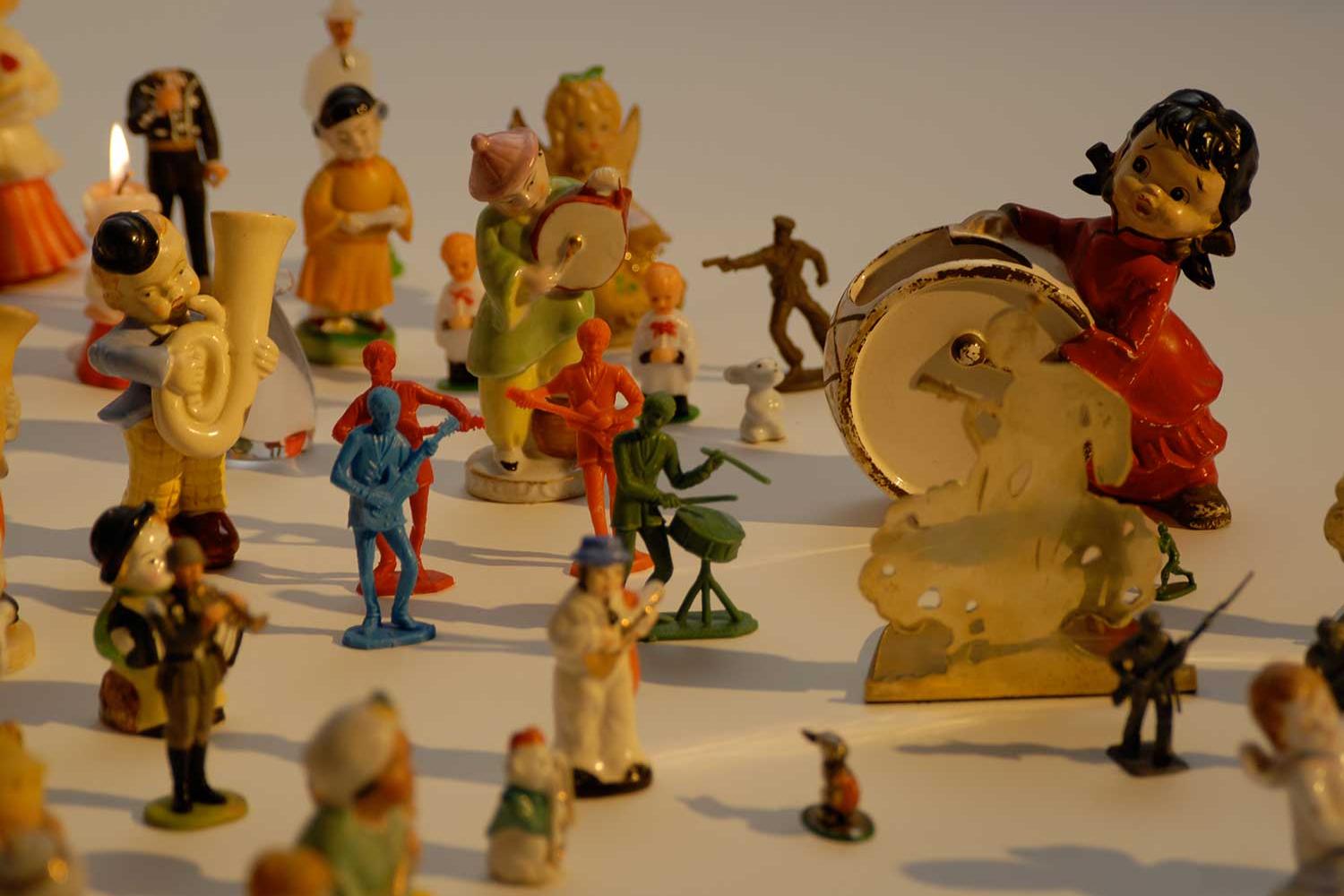 Various colorful toy figurines arranges on white background