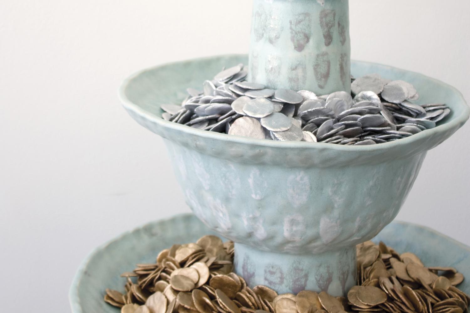Ceramic fountain filled with ceramic coins.