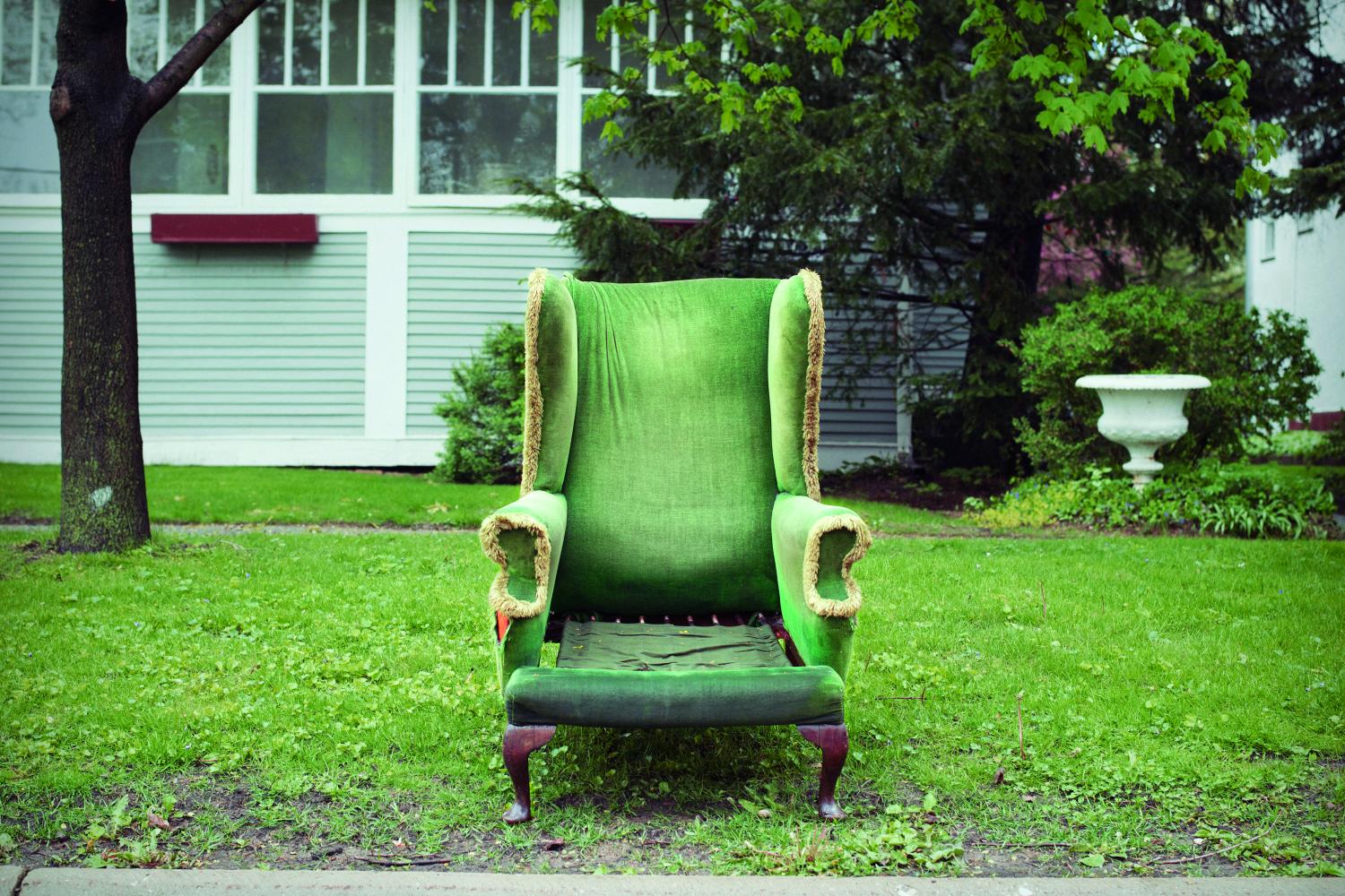Photograph of a green chair in a driveway