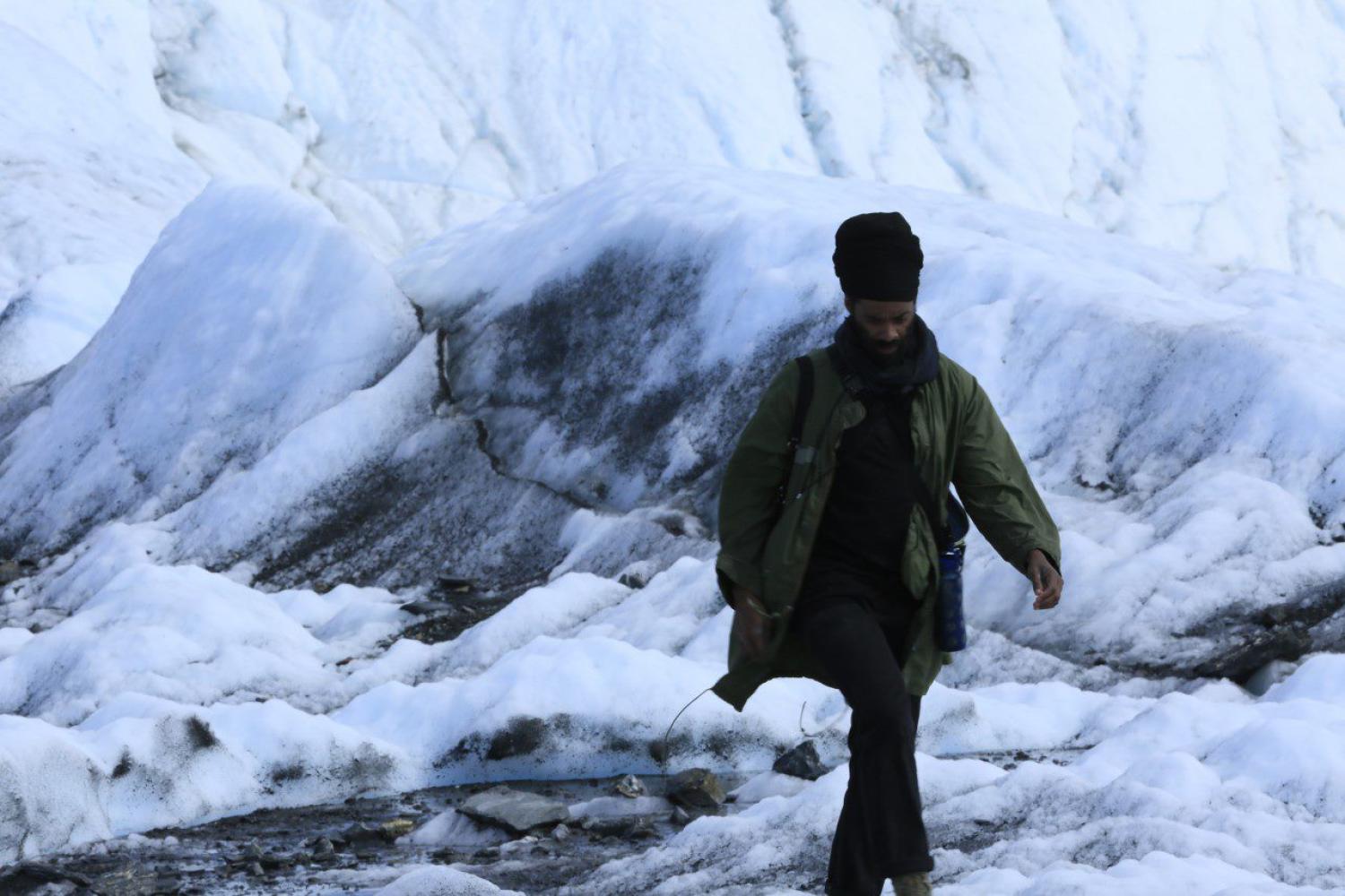 Photo of a man standing in snow.