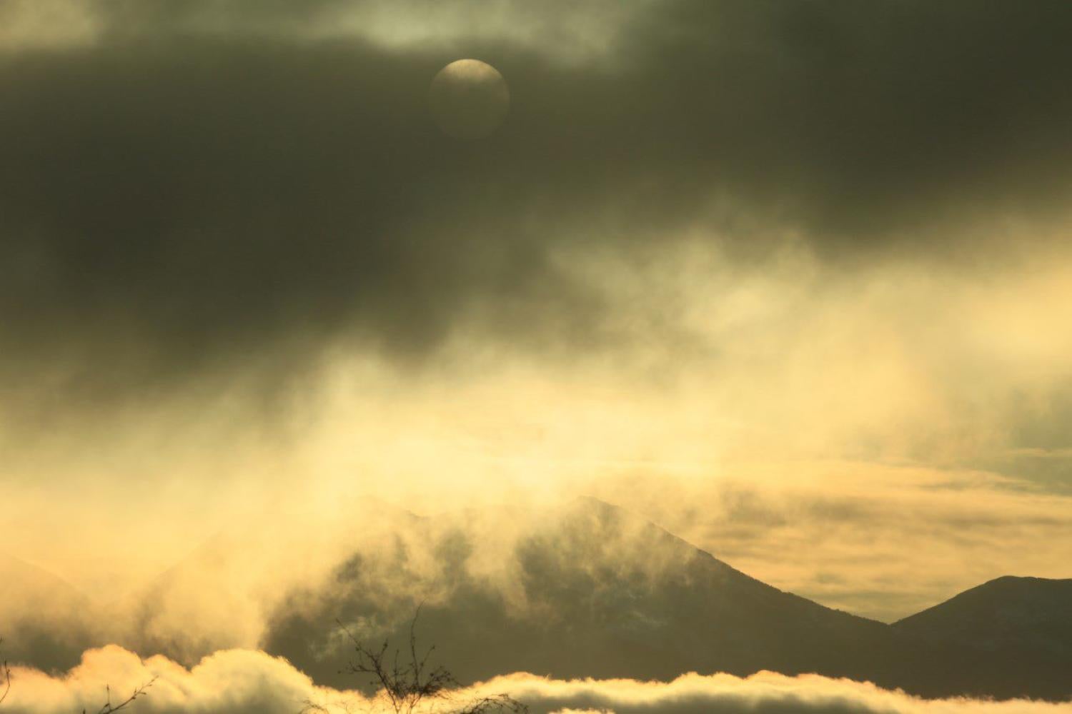 Photo of a sepia-colored landscape with clouds.
