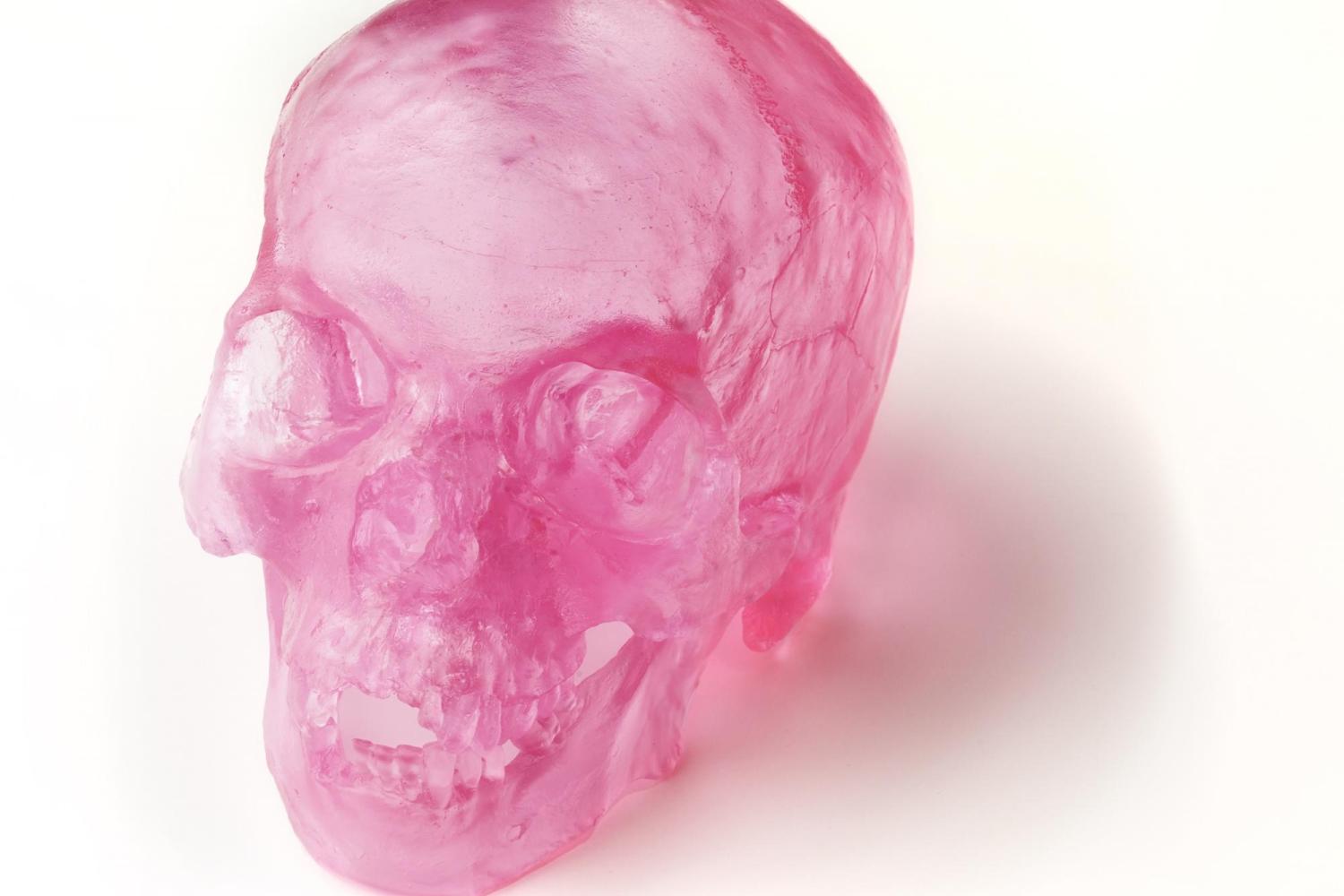 a pink glass human skull