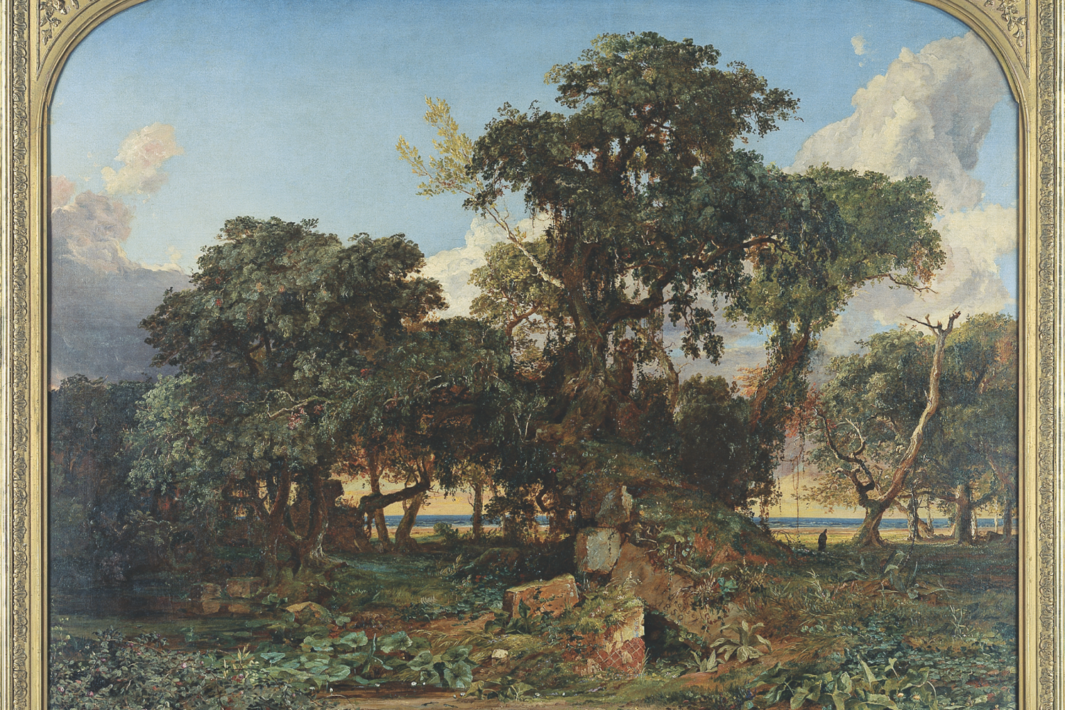 A framed landscape painting depicting trees and overgrowth on top of the ruins of an old building.