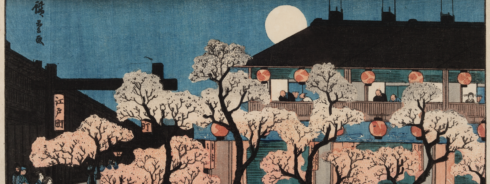 A Japanese woodblock print depicting an outdoor scene at night. There are many people walking around and looking out of a building with many trees with pink foliage in the foreground. The full moon peeks out from behind the black roof of the building.