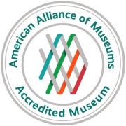 AAM Accreditation Logo in teal, pink, and orange. Text in a circle reads "American Alliance of Museums Accredited Museum."