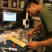 team member working on satellite prototype
