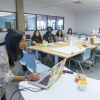Instructor at computer, group of students at desk