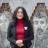 Photo of Cassandra in front of Los Seis mural