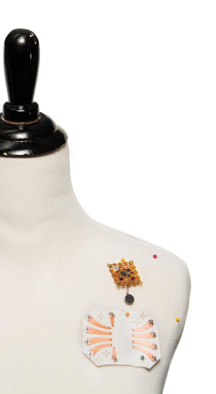 manikin with wearable technology devise pinned to chest area