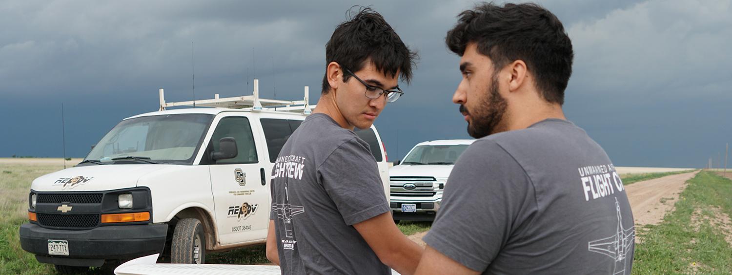 CU Boulder students hold a drone while researching severe weather