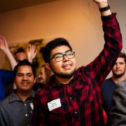 Group of men raising hands