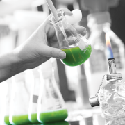 CU Boulder student in a lab with beaker