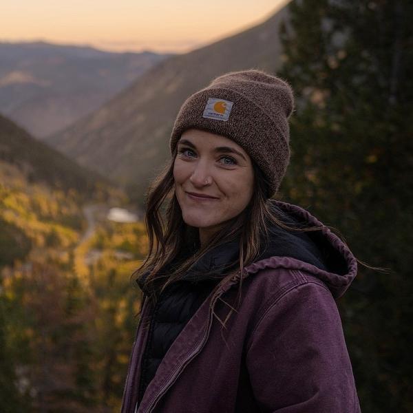 Anna Paraskevopoulos in winter hat and coat in the mountains